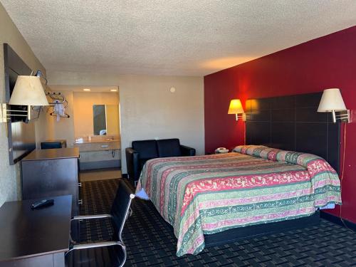 a hotel room with a bed and a bathroom at Kings Inn Civic Center/UAB in Birmingham