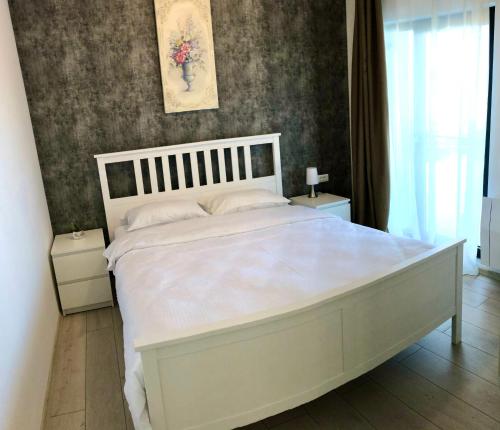 Ένα ή περισσότερα κρεβάτια σε δωμάτιο στο Snagov Lakeview Residences