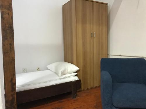 a bedroom with a bed and a wooden cabinet at Apartmani Košuta in Tjentište