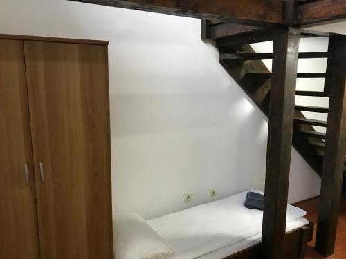 a room with a bunk bed next to a wooden cabinet at Apartmani Košuta in Tjentište