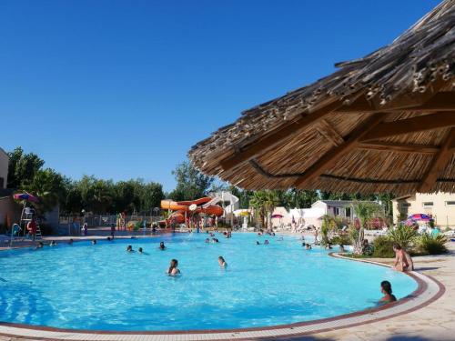 a group of people in a pool at a resort at Les sable du midi 3 in Valras-Plage