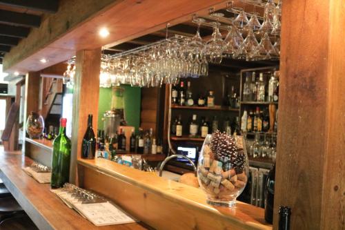 a bar with a counter with bottles of wine at Hotel Ladera in Boquete