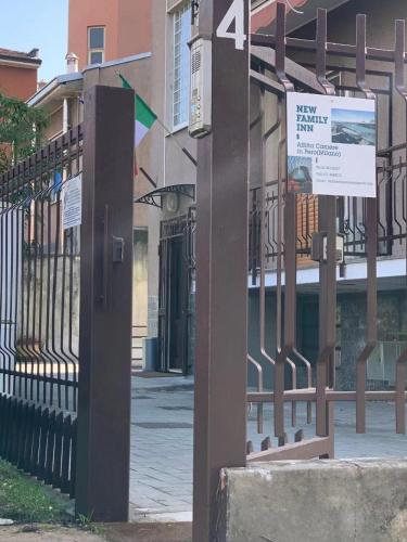 a sign on a fence next to a building at NEW FAMILY INN in Pero