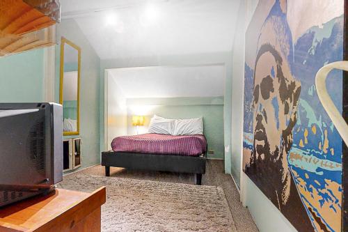 a bedroom with a bed and a tv in it at Beach Bum Bungalow in Folly Beach
