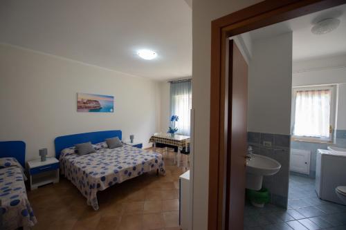 A bed or beds in a room at Appartamenti Attilio
