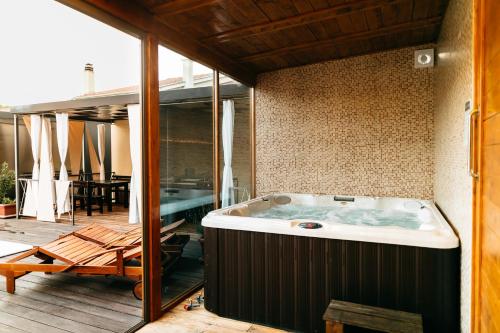 a jacuzzi tub on a patio with a table at Illyria in Skradin