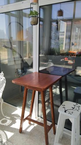 a wooden table and a bench in front of a window at Forever São Brás in São Brás de Alportel