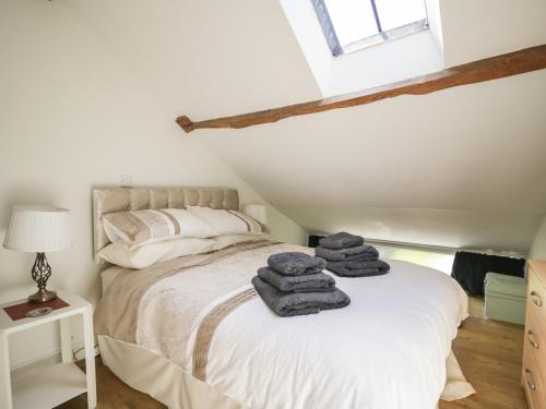 a bedroom with a bed with towels on it at Swallows Nest in Carlisle
