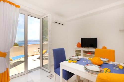 a dining room with a table and a view of the ocean at Casa Floriana Seaview in Capri