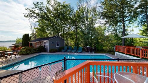 a swimming pool with an orange fence around it at The Lakeview Inn & Cottages in Weirs Beach