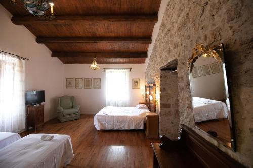 a hotel room with two beds and a mirror at Dimora BOUQUET & GOURMET in Ascoli Piceno