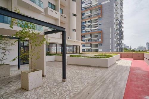 a building with a courtyard with plants in it at Escape Apartments, Balcony, Pool, Gym & Spa in La Julia in Santo Domingo