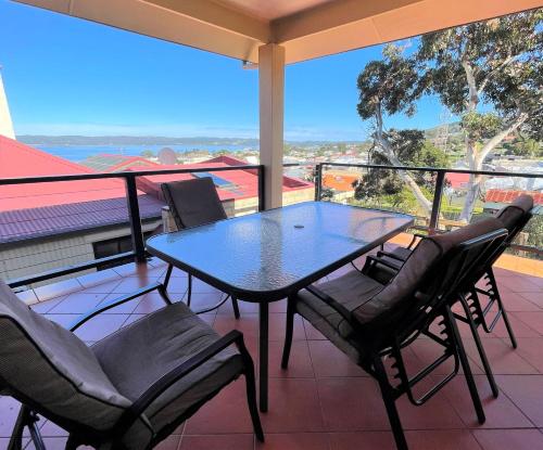 a table and chairs on a balcony with a view at Views on Spencer in Albany