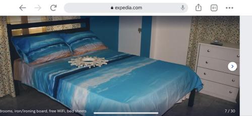 a bedroom with a bed with a blue comforter at Casa Peace Haven Beach House Aguada in Aguada
