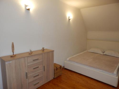 a bedroom with a bed and a dresser and lights at Sibiu Home 4 Green in Sibiu
