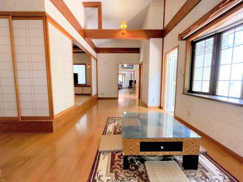 a living room with a table on a rug at Mariudo / Two-Bedroom & a Japanese-style-room House in Ishigaki Island