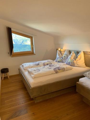 a bedroom with a large bed with a window at Haus Bergheim in Unken