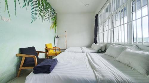 two beds in a room with a large window at No.9 The Forest @ Dream and Relaxing House at Puchong Center in Puchong