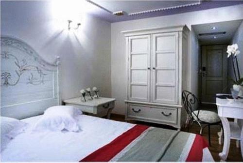 a bedroom with a bed and a desk and a sink at Arhontiko Pepos in Nafpaktos