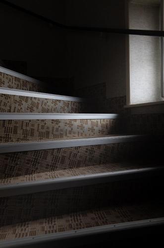 an empty staircase in a room with a window at Hôtel Modern in Concarneau