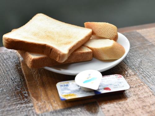 a plate with two slices of toast on a table at Hotel Resol Akihabara in Tokyo