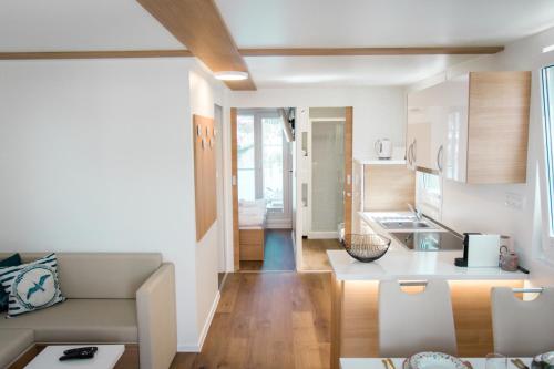 a kitchen and living room with a couch and a table at SH Porto 2 Floating House, Marina Portorož in Portorož