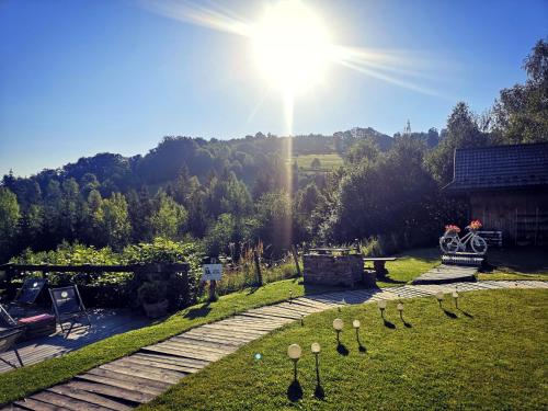 a view of a garden with the sun in the sky at Czarna Owca in Istebna