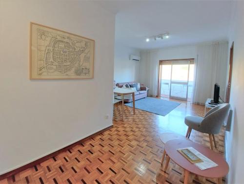 a living room with a drawing on the wall at Braga centro - apartamento espaçoso e confortável - Todas as comodidades in Braga
