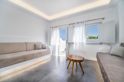a living room with a couch and a table at Serenità Luxury Suites in Akrotiri