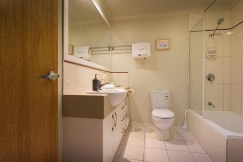 a bathroom with a toilet and a sink and a tub at ARTHUR RIVER LODGE UPSTREAM in Arthur River