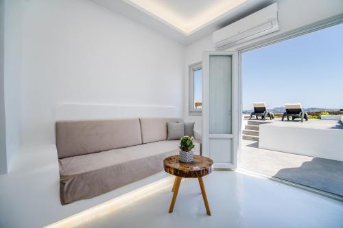 a living room with a couch and a table at Serenità Luxury Suites in Akrotiri