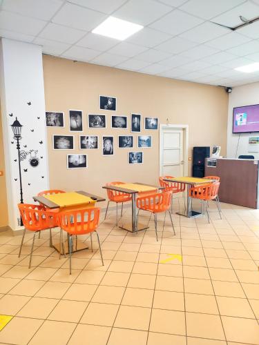 a classroom with tables and chairs and pictures on the wall at basilicata al volo in Brindisi di Montagna