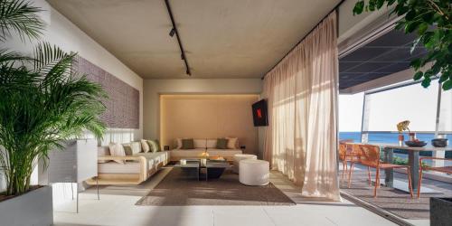 a living room with a view of the ocean at 3 Olive Trees in Anavissos