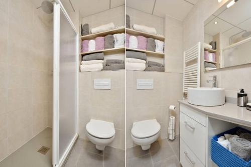 a white bathroom with a toilet and a sink at COSY WELL SITUED APARTMENT WITH SEA VIEW in Vilanova i la Geltrú
