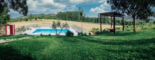 a yard with a swimming pool in a field at Quinta Ponte da Capinha in Capinha