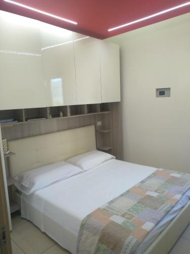 a bedroom with a bed and white cabinets at B&B Vistamareblu in San Foca