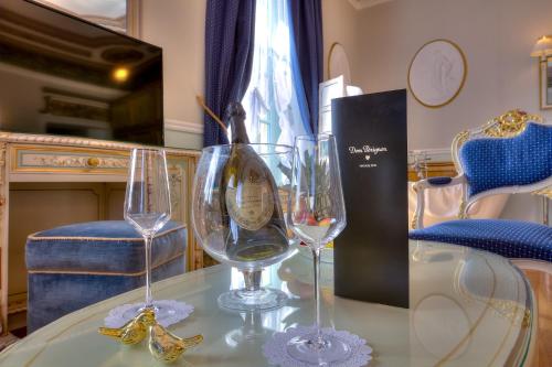 two wine glasses sitting on top of a table at ABA LUXURY B E B Nice in Nice