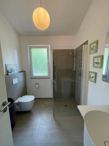 a bathroom with a shower and a toilet and a sink at FEWO Sunshine in Villingen-Schwenningen