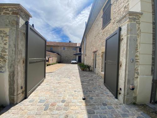 an alley with two large doors on a building at Castel serein in Maubec