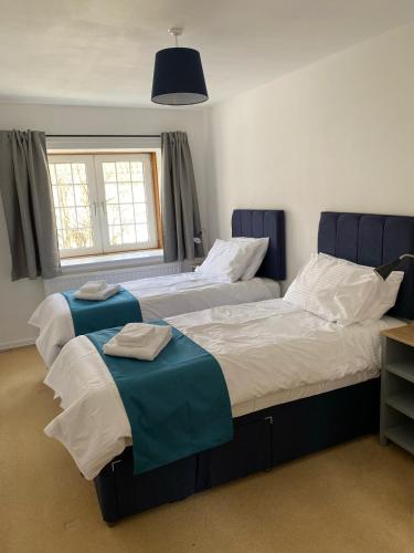 a bedroom with two beds and a window at The Crail Maltings in Crail