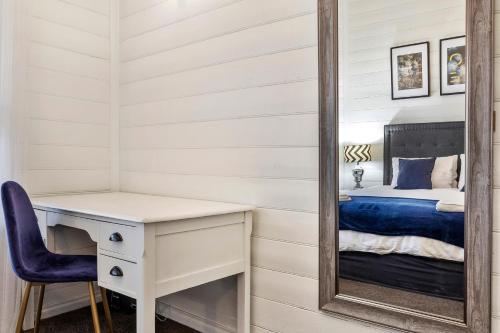 a bedroom with a mirror and a desk and a bed at White on Wright Clare in Clare