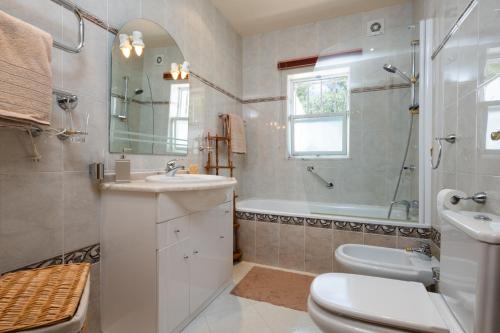 a bathroom with a sink and a toilet and a shower at VILLA DOMIPAJO in Carvoeiro