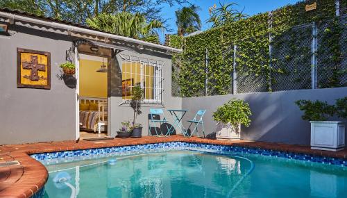 a swimming pool in the backyard of a house at Tamarisk Bed & Breakfast in Durban