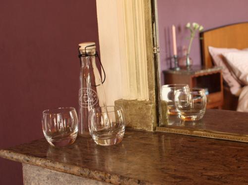 a group of wine glasses sitting on a table in front of a mirror at MaDamenFrance in Monclar-dʼAgenais