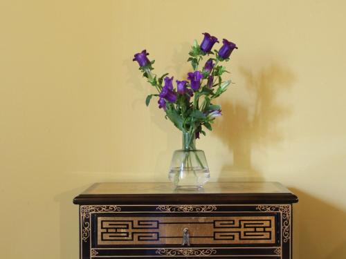 a vase of purple flowers sitting on top of a table at MaDamenFrance in Monclar-dʼAgenais
