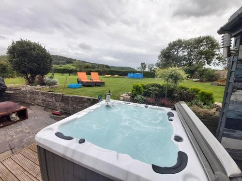 a hot tub sitting on top of a deck at Bluebell House 5 Star Holiday Let in Somerton