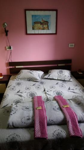 a bed with two pillows and two towels on it at Стаи за гости ОРЕХА Троян Private rooms Oreha in Troyan