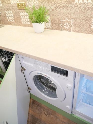 a laundry room with a washer and dryer under a counter at Penzion a restaurace U Červinků in Čistá u Horek