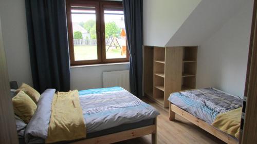 A bed or beds in a room at Agroturystyka Pod Szczytem