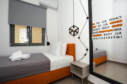 a small bedroom with a bed and a mirror at Villagio House in Falasarna